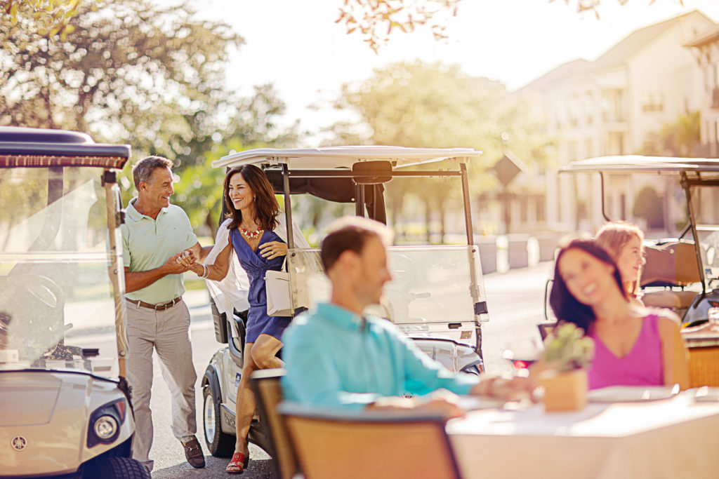 Women stepping out of a golf cart