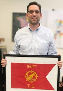 Man standing holding a flag